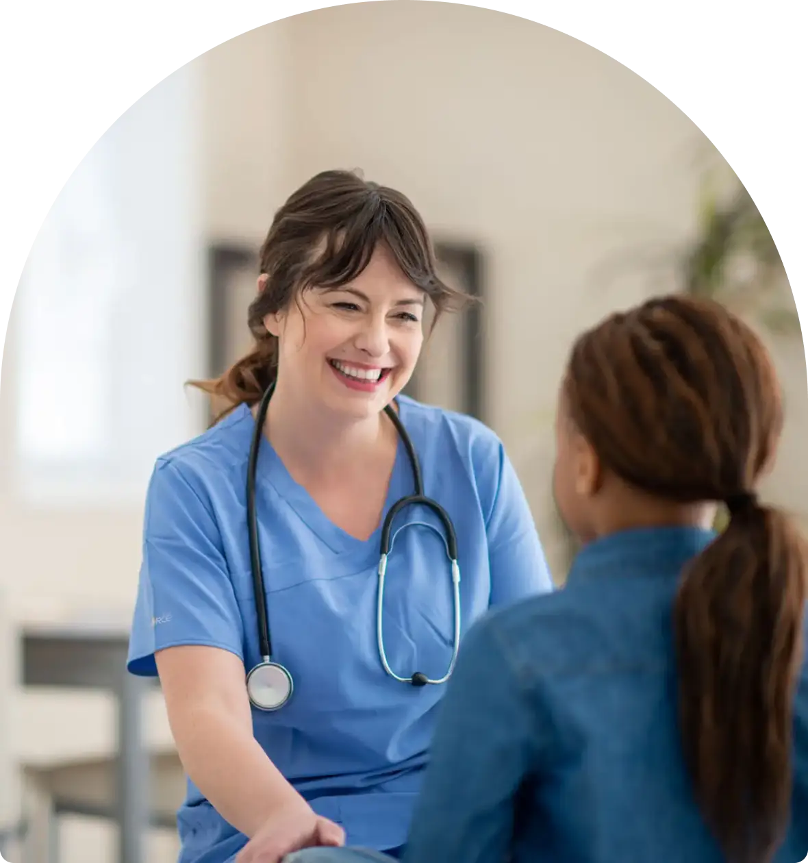 A female doctor attentively talking to a patient.